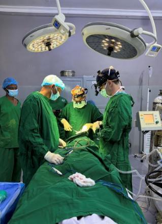 Shot of surgeons in green in the operating room