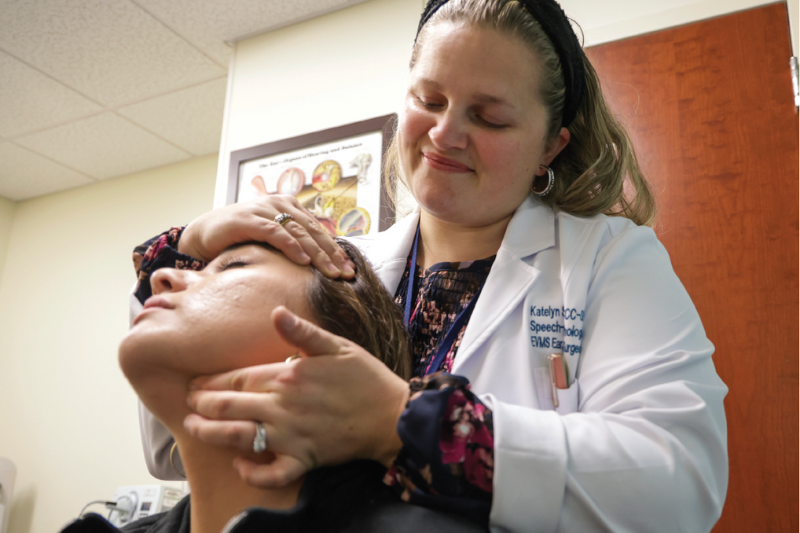 Katelyn Swiader examines a patient in the Voice and Swallowing Center