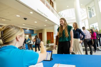 New students at a check-in table during orientation